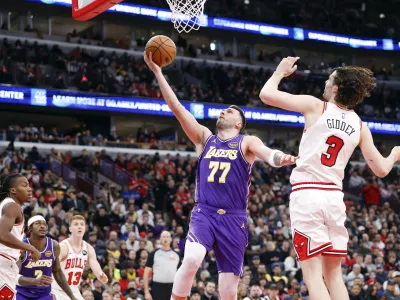 Jan 26, 2026; Chicago, Illinois, USA; Los Angeles Lakers guard Luka Doncic (77) goes to the basket against Chicago Bulls guard Josh Giddey (3) during the second half at United Center. Mandatory Credit: Kamil Krzaczynski-Imagn Images