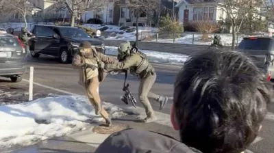 This image taken from video by Max Shapiro shows Alex Pretti, left, scuffling with federal immigration officers in Minneapolis on Jan. 13, 2026. (Max Shapiro via AP)