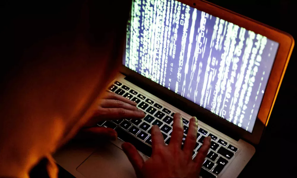 A hacker in action behind a computer. A hacker (sometimes also called a squatter or cracker) is a person who penetrates a computer network by evading security. There are hackers with criminal intentions (black hats); for many, however, it is a sport to crack secure networks and where possible to report ethically. Netherlands on March 14, 2022. Photo by Robin Utrecht/ABACAPRESS.COMNo Use Netherlands. No Use Germany.