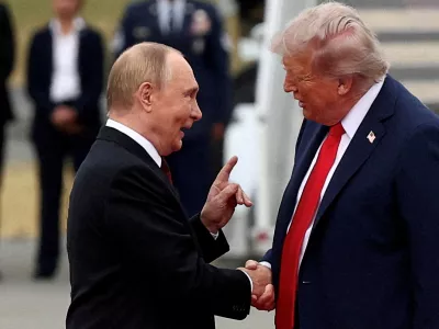 FILE PHOTO: U.S. President Donald Trump shakes hand with Russian President Vladimir Putin, as they meet to negotiate for an end to the war in Ukraine, at Joint Base Elmendorf-Richardson in Anchorage, Alaska, U.S., August 15, 2025. REUTERS/Kevin Lamarque/File Photo