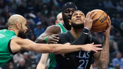 Feb 3, 2026; Dallas, Texas, USA; Dallas Mavericks forward Daniel Gafford (21) looks to score as Boston Celtics guard Derrick White (9) defends during the first quarter at American Airlines Center. Mandatory Credit: Kevin Jairaj-Imagn Images
