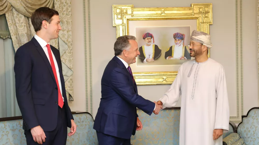 In this photo released by the Oman's Foreign Ministry, Steve Witkoff, White House special envoy, centre, shakes hands with Oman's Foreign Minister Sayyid Badr Albusaidi as Jared Kushner, left, looks on during their meeting prior to Iran and the U.S. negotiations, in Muscat, Oman, Friday, Feb. 6, 2026. (Oman Foreign Ministry via AP)
