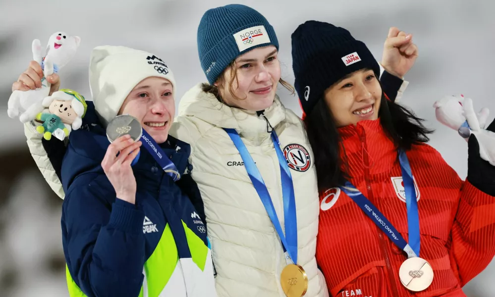 Milano Cortina 2026 Olympics - Ski Jumping - Women's Normal Hill Individual Victory Ceremony - Predazzo Ski Jumping Stadium, Predazzo, Italy - February 07, 2026. Gold medallist Anna Odine Stroem of Norway celebrates on the podium after winning the Women's Normal Hill Individual with silver medallist Nika Prevc of Slovenia and bronze medallist Nozomi Maruyama of Japan REUTERS/Stephanie Lecocq