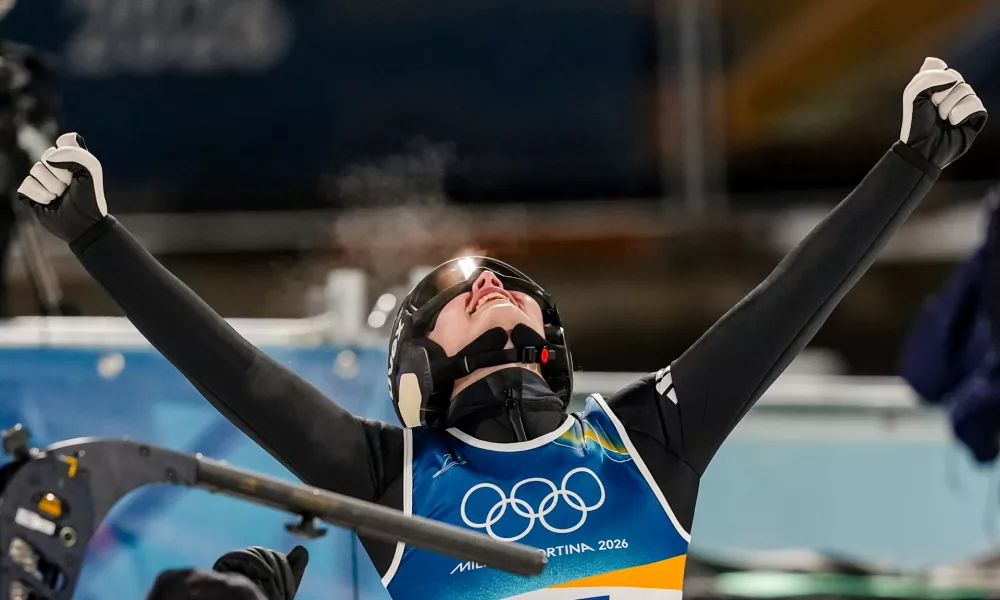 Anna Odine Stroem, of Norway, celebrates after winning the gold medal in the ski jumping women's normal hill individual, at the 2026 Winter Olympics, in Predazzo, Italy, Saturday, Feb. 7, 2026. (AP Photo/Matthias Schrader)