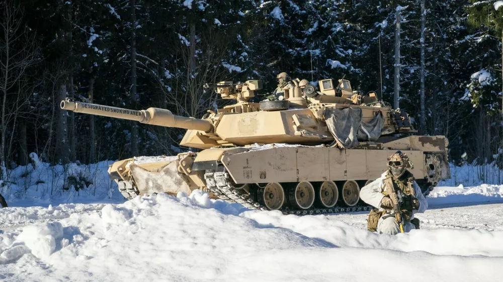 American Abrams tanks pass British soldiers from the 2nd Battalion The Royal Anglian Regiment (The Poachers) as they engage enemy troops on the Tapa range in Estonia where British soldiers are taking part in Exercise Winter Camp, which is part of Operation Cabrit, the UK's contribution to Nato's Forward Land Forces in Estonia and Poland. Picture date: Tuesday February 3, 2026.,Image: 1071924408, License: Rights-managed, Restrictions:, Model Release: no