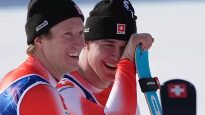 Switzerland's Franjo von Allmen, right, and teammate Switzerland's Nef Tanguy, celebrate winning the gold medal in an alpine ski men's team combined race, at the 2026 Winter Olympics, in Bormio, Italy, Monday, Feb. 9, 2026. (AP Photo/Rebecca Blackwell)