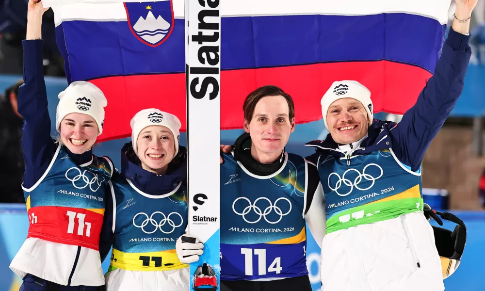 10 February 2026, Italy, Predazzo: (L-R) Slovenia's Nika Vodan, Nika Prevc, Domen Prevc and Anze Lanisek celebrate after the Ski Jumping Mixed team competition of the 2026 Winter Olympic Games at Milan-Cortina. Photo: Daniel Karmann/dpa