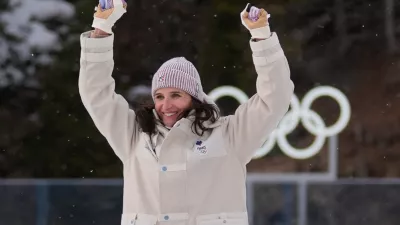 Julia Simon, of France, celebrates gold during a medals ceremony for the women's 15-kilometer individual biathlon race at the 2026 Winter Olympics in Anterselva, Italy, Wednesday, Feb. 11, 2026. (AP Photo/Andrew Medichini)