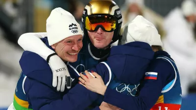 Milano Cortina 2026 Olympics - Ski Jumping - Mixed Team - Predazzo Ski Jumping Stadium, Predazzo, Italy - February 10, 2026. Nika Vodan of Slovenia, Anze Lanisek of Slovenia, Domen Prevc of Slovenia and Nika Prevc of Slovenia celebrate winning the gold medal after the final round. REUTERS/Kai Pfaffenbach