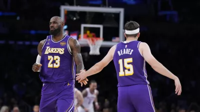 Los Angeles Lakers forward LeBron James (23) and guard Austin Reaves (15) celebrate a basket during the second half of an NBA basketball game against the Oklahoma City Thunder Monday, Feb. 9, 2026, in Los Angeles. (AP Photo/Jae C. Hong)