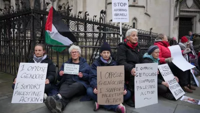 Supporters of Palestine Action stage a protest outside the Royal Court of Justice in London, Friday, Feb. 13, 2026. (AP Photo/Kin Cheung)