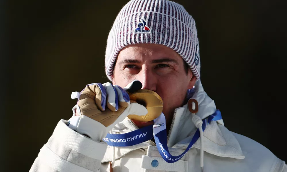 Milano Cortina 2026 Olympics - Biathlon - Men's 10km Sprint Victory Ceremony - Anterselva Biathlon Arena, South Tyrol, Italy - February 13, 2026. Gold medallists Quentin Fillon Maillet of France celebrates on the podium after winning Men's 10km Sprint REUTERS/Eloisa Lopez