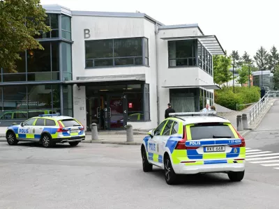 Police vehicles are parked in front of a school following a shooting incident in Trangsund, Huddinge, Sweden September 4, 2024. TT News Agency/Jonas Ekstromer/via REUTERS   ATTENTION EDITORS - THIS IMAGE WAS PROVIDED BY A THIRD PARTY. SWEDEN OUT. NO COMMERCIAL OR EDITORIAL SALES IN SWEDEN.