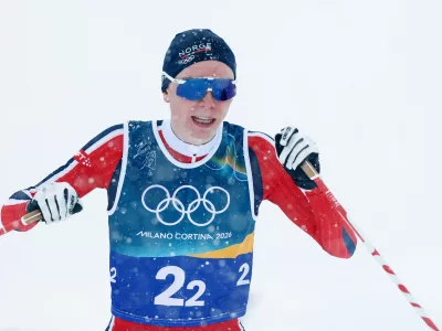 Milano Cortina 2026 Olympics - Nordic Combined - Team Sprint, Cross-Country - Tesero Cross-Country Skiing Stadium, Lago, Italy - February 19, 2026. Jens Luraas Oftebro of Norway celebrates as he crosses the finish line to win gold REUTERS/Kai Pfaffenbach