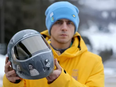 Milano Cortina 2026 Olympics - Skeleton - IOC President Kirsty Coventry meets skeleton racer Vladyslav Heraskevych of Ukraine - Cortina Sliding Centre, Cortina d'Ampezzo, Italy - February 12, 2026. Vladyslav Heraskevych of Ukraine shows his helmet following his disqualification from Olympic competition for wearing it in tribute to athletes who have died amid Russia's attack on Ukraine after a scheduled meeting with IOC President Kirsty Coventry REUTERS/Athit Perawongmetha   TPX IMAGES OF THE DAY