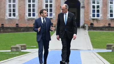 HANDOUT - 12 February 2026, Belgium, Bilzen: German Chancellor Friedrich Merz and French President Emmanuel Macron arrive to the EU leader's informal meeting in Bilzen. Photo: FREDERIC SIERAKOWSKI/European Council/dpa - ATTENTION: editorial use only and only if the credit mentioned above is referenced in full