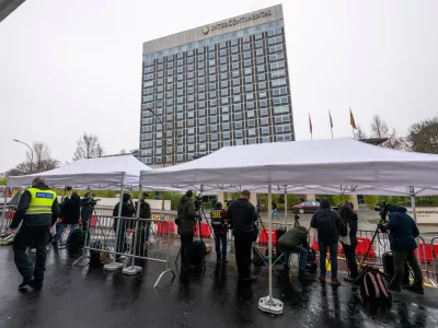 Journalists gather outside the entrance of the Intercontinental Hotel where U.S., Ukraine and Russia are meeting to discuss peace plan, in Geneva, Switzerland, Wednesday, Feb. 18, 2026. (Martial Trezzini/Keystone via AP)