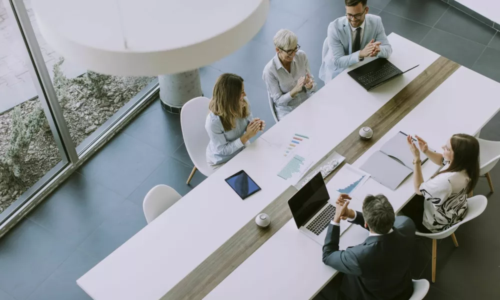 Aerial view at group of business people working together and preparing new project on a meeting in the office