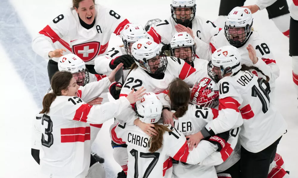 Team Switzerland players celebrate after Alina Muller (25) scored the winning goal in overtime to beat Sweden in the women's ice hockey bronze medal game at the 2026 Winter Olympics, in Milan, Italy, Thursday, Feb. 19, 2026. (AP Photo/Carolyn Kaster)