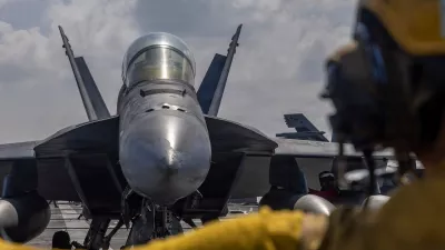 This handout photograph from the U.S. Navy shows Aviation Boatswain's Mate 2nd Class Michael Cordova directing an F/A-18F Super Hornet on the flight deck of the Nimitz-class aircraft carrier USS Abraham Lincoln in the Indian Ocean on Jan. 23, 2026. (Mass Communication Specialist Seaman Daniel Kimmelman/U.S. Navy via AP)