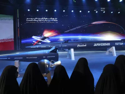 FILE - Women look at Fattah missile in a ceremony in Tehran, Iran, Tuesday, June 6, 2023. (Hossein Zohrevand/Tasnim News Agency via AP, File)
