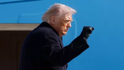President Donald Trump gestures from the stairs of Air Force One upon his arrival at Joint Base Andrews, Md., Friday, Feb. 27, 2025. (AP Photo/Luis M. Alvarez)