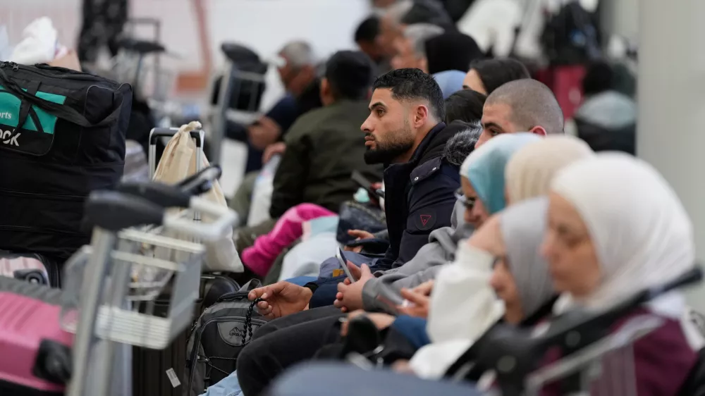Passengers whose flights were cancelled, wait at the departure terminal of Rafik Hariri International Airport in Beirut, Lebanon, Saturday, Feb. 28, 2026, as many airlines canceled flights due to the conflict involving the United States, Israel and Iran. (AP Photo/Hassan Ammar)