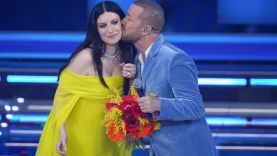 Raf and Laura Pausini onstage during the 76th edition of the Sanremo Italian Song Festival at the Ariston Theatre, in Sanremo, Italy, Thursday, Feb. 26, 2026. (Marco Alpozzi/LaPresse via AP)