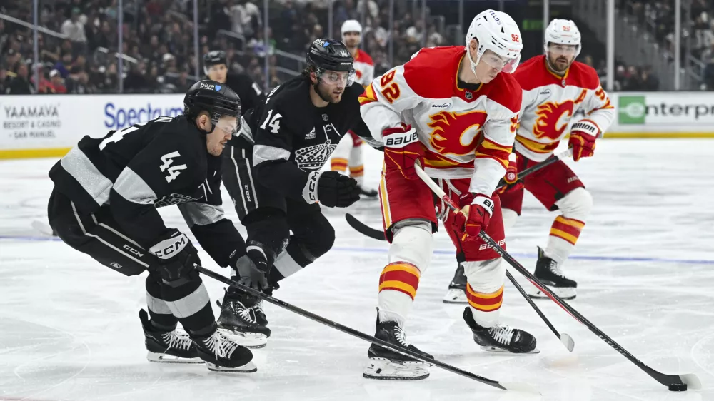 Feb 28, 2026; Los Angeles, California, USA; Calgary Flames right wing Matvei Gridin (92) battles for the puck during the third period against the Los Angeles Kings at Crypto.com Arena. Mandatory Credit: Griffin Hooper-Imagn Images