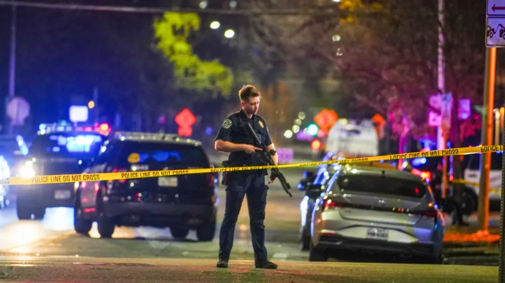 An Austin police officer guards the scene on West 6th Street at West Avenue after a shooting, Sunday March 1, 2026, in Austin, Texas. (Ricardo B. Brazziell/Austin American-Statesman via AP)