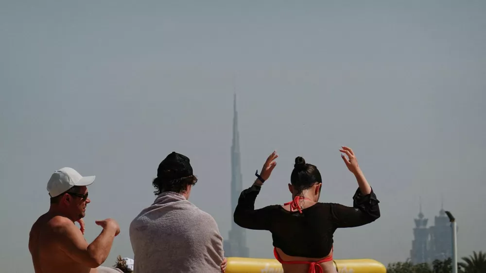 People relax at the Kite Beach with Burj Khalifa in the background, after an Iranian attack, following United States and Israel strikes on Iran, in Dubai, United Arab Emirates, March 1, 2026. REUTERS/Amr Alfiky REFILE - CHANGING HEADLINE