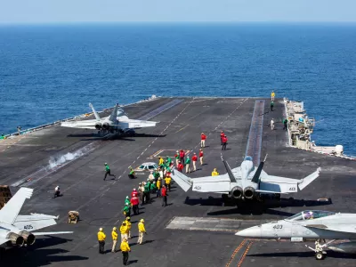 This image provided by U.S. Central Command shows a F/A-18E Super Hornet launching at left, as an F/A-18E Super at right, prepares to launch from the flight deck of Nimitz-class aircraft carrier USS Abraham Lincoln (CVN 72) in support of Operation Epic Fury, on Saturday, Feb. 28, 2026. (U.S. Navy via AP)