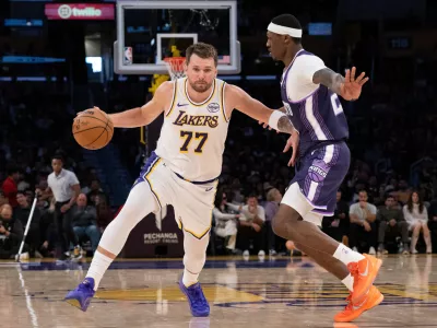 Los Angeles Lakers guard Luka Doncic drives to the basket as Sacramento Kings guard Daeqwon Plowden defends during the second half of an NBA basketball game in Los Angeles, Sunday, March 1, 2026. (AP Photo/Kyusung Gong)