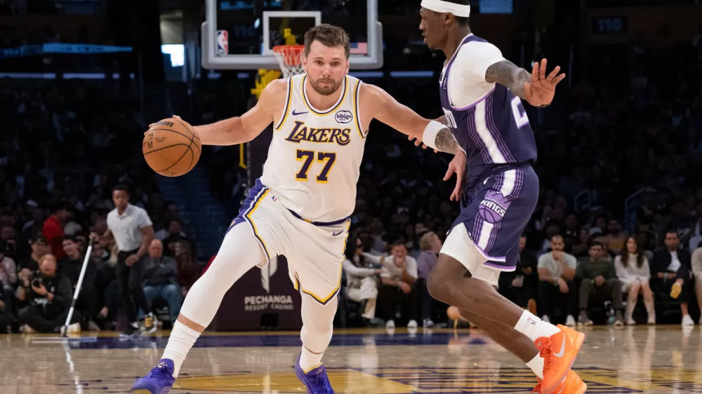 Los Angeles Lakers guard Luka Doncic drives to the basket as Sacramento Kings guard Daeqwon Plowden defends during the second half of an NBA basketball game in Los Angeles, Sunday, March 1, 2026. (AP Photo/Kyusung Gong)