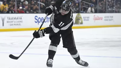 Feb 28, 2026; Los Angeles, California, USA; Los Angeles Kings center Anze Kopitar (11) shoots the puck during the second period against the Calgary Flames at Crypto.com Arena. Mandatory Credit: Griffin Hooper-Imagn Images
