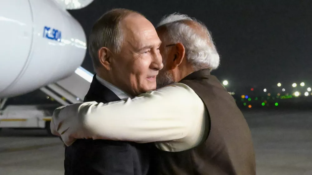 Russian President Vladimir Putin, left, and Indian Prime Minister Narendra Modi embrace each other at the Palam Air Base in New Delhi, India, Thursday, Dec. 4, 2025. (Grigory Sysoyev, Sputnik, Kremlin Pool Photo via AP)
