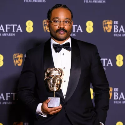 3DTM9RD London, UK. 22 February 2026. Ryan Coogler poses with the Original Screenplay Award for 'Sinners' during the 79th British Academy Film Awards, at the Royal Festival Hall, Southbank Centre, London. Photo credit should read: Matt Crossick/Alamy Live News