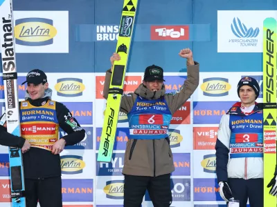 Ski Jumping - Four Hills Tournament - Innsbruck, Austria - January 4, 2026 Japan's Ren Nikaido celebrates on the podium after winning the Men's Individual HS128 alongside second place Slovenia's Domen Prevc and third place Austria's Stephan Embacher REUTERS/Kai Pfaffenbach