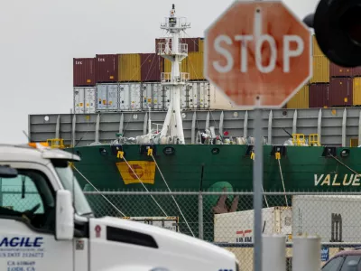 FILE PHOTO: A view of cargo ship with shipping containers at the port of Oakland following the Supreme Court's ruling that Trump had exceeded his authority when he imposed tariffs, in Oakland, California, U.S., February 23, 2026. REUTERS/Carlos Barria/File Photo