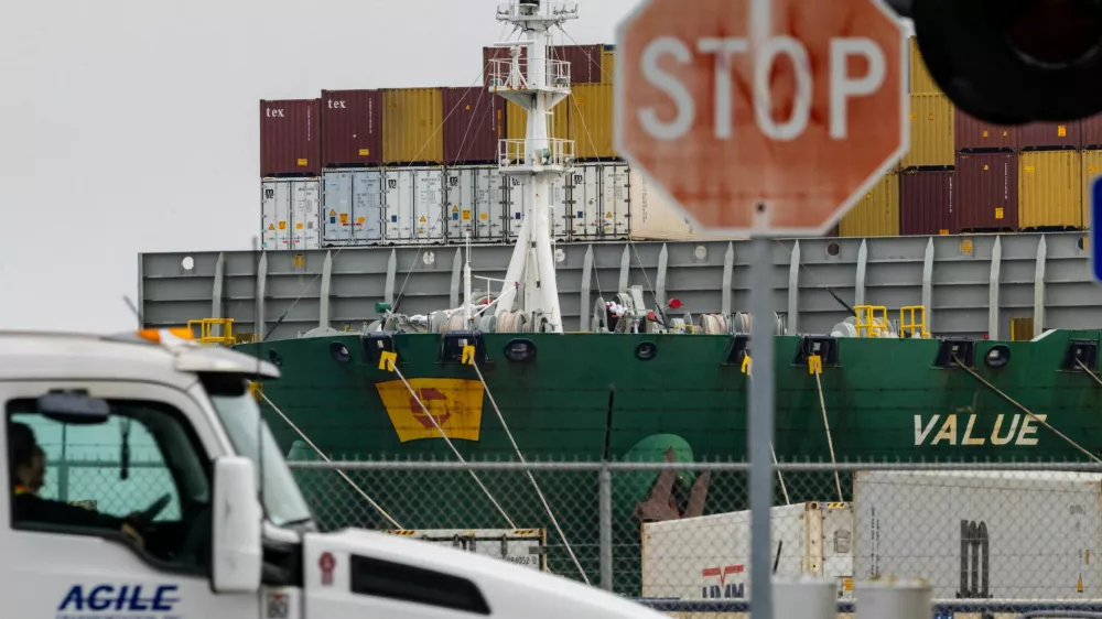 FILE PHOTO: A view of cargo ship with shipping containers at the port of Oakland following the Supreme Court's ruling that Trump had exceeded his authority when he imposed tariffs, in Oakland, California, U.S., February 23, 2026. REUTERS/Carlos Barria/File Photo