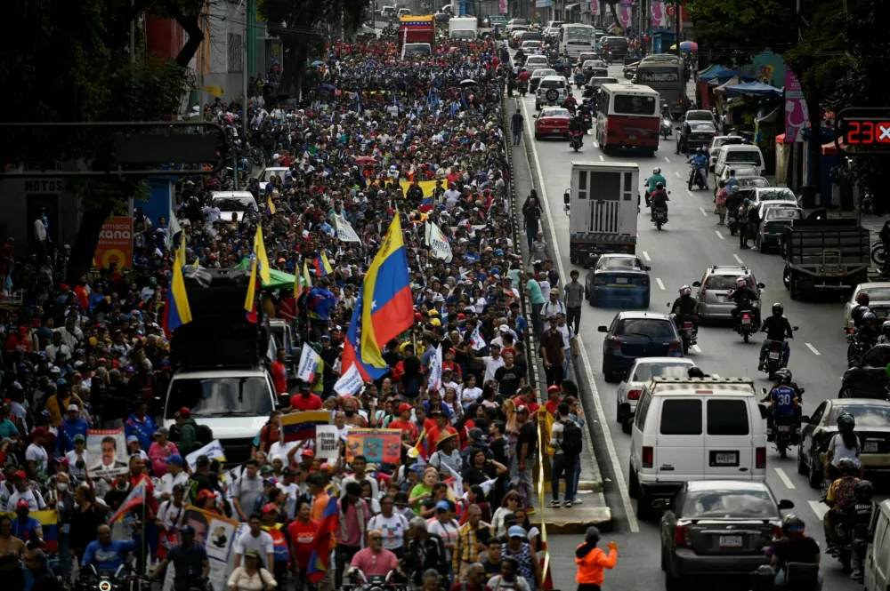 Supporters of Venezuela's government rally to demand the release of ousted President Nicolas Maduro and his wife, Cilia Flores, two months after their capture by the U.S., in Caracas, Venezuela, March 3, 2026. REUTERS/Maxwell Briceno   TPX IMAGES OF THE DAY