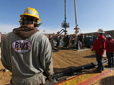 In this March 25, 2014 photo, workers keep an eye on well heads during a hydraulic fracturing operation at an Encana Corp. oil well, near Mead, Colo. The first experimental use of hydraulic fracturing was in 1947, and more than 1 million U.S. oil and oil wells have been fracked since, according to the American Petroleum Institute. The National Petroleum Council estimates that up to 80 percent of natural oil wells drilled in the next decade will require hydraulic fracturing. (AP Photo/Brennan Linsley)