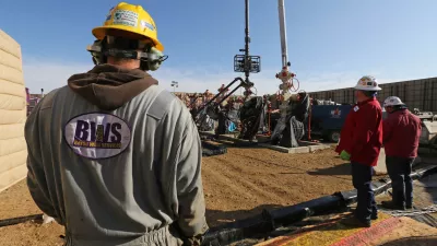 In this March 25, 2014 photo, workers keep an eye on well heads during a hydraulic fracturing operation at an Encana Corp. oil well, near Mead, Colo. The first experimental use of hydraulic fracturing was in 1947, and more than 1 million U.S. oil and oil wells have been fracked since, according to the American Petroleum Institute. The National Petroleum Council estimates that up to 80 percent of natural oil wells drilled in the next decade will require hydraulic fracturing. (AP Photo/Brennan Linsley)