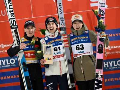 Second placed Domen Prevc, of Slovenia, from left, winner Daniel Tschofenig of Austria and third placed Ryoyu Kobayashi of Japan celebrate on the podium after the men's ski jumping Large Hill HS130 at the FIS Nordic World Cup Lahti Ski Games in Lahti,, Finland, Saturday March 7, 2026. (Emmi Korhonen/Lehtikuva via AP)