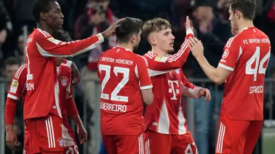 Bayern's Nicolas Jackson, left, celebrates with team mates Raphael Guerreiro (22), Lennart Karl (42) and Josip Stanisic (44) after scoring his side's fourth goal during the Bundesliga soccer match between FC Bayern Munich and Borussia Moenchengladbach in Munich, Germany, March 6, 2026. (AP Photo/Matthias Schrader)
