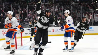 Mar 5, 2026; Los Angeles, California, USA; LA Kings center Anze Kopitar (11) celebrates after a goal as New York Islanders defenseman Adam Pelech (3) and defenseman Carson Soucy (4)8 react in the second period at Crypto.com Arena. Mandatory Credit: Kirby Lee-Imagn Images