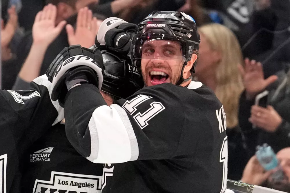 Los Angeles Kings defenseman Mikey Anderson, left, celebrates his goal with center Anze Kopitar during the second period of an NHL hockey game against the New York Islanders, Thursday, March 5, 2026, in Los Angeles. (AP Photo/Mark J. Terrill)