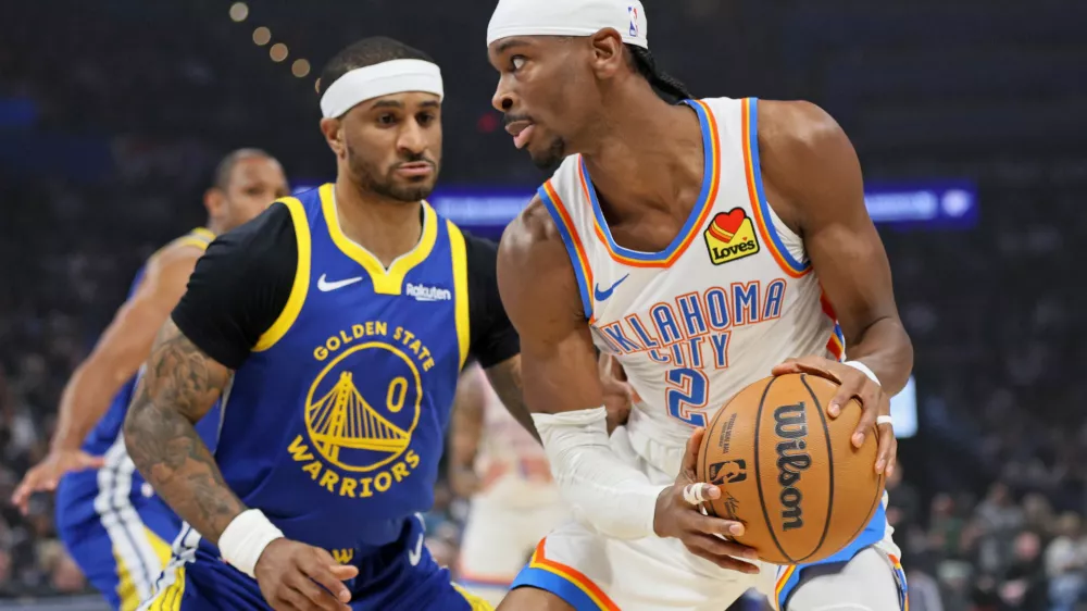 Oklahoma City Thunder guard Shai Gilgeous-Alexander (2) looks for an outlet against Golden State Warriors guard Gary Payton II (0) during the first half of an NBA basketball game Saturday, March 7, 2026, in Oklahoma City. (AP Photo/Nate Billings)