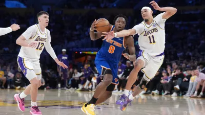 Mar 8, 2026; Los Angeles, California, USA; New York Knicks forward Og Anunoby (8) dribbles against Los Angeles Lakers center Jaxson Hayes (11) and forward Jake LaRavia (12) in the first half at Crypto.com Arena. Mandatory Credit: Kirby Lee-Imagn Images
