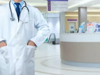 Smart doctor with a stethoscope around his neck on the hospital blurred background, Healthcare medical technology concept, copy space, Color effect tone, Copy space for text.,Image: 922087993, License: Royalty-free, Restrictions:, Model Release: yes